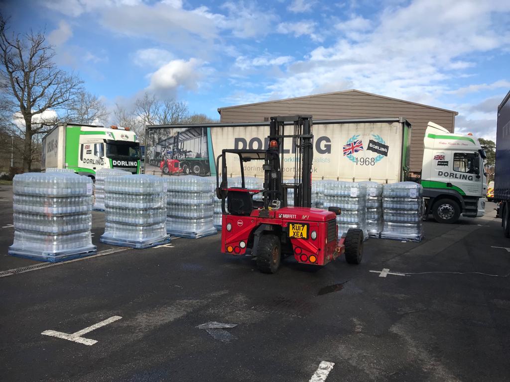 One of our Truck Mounted Forklifts delivering palletised water on an emergency transport job.