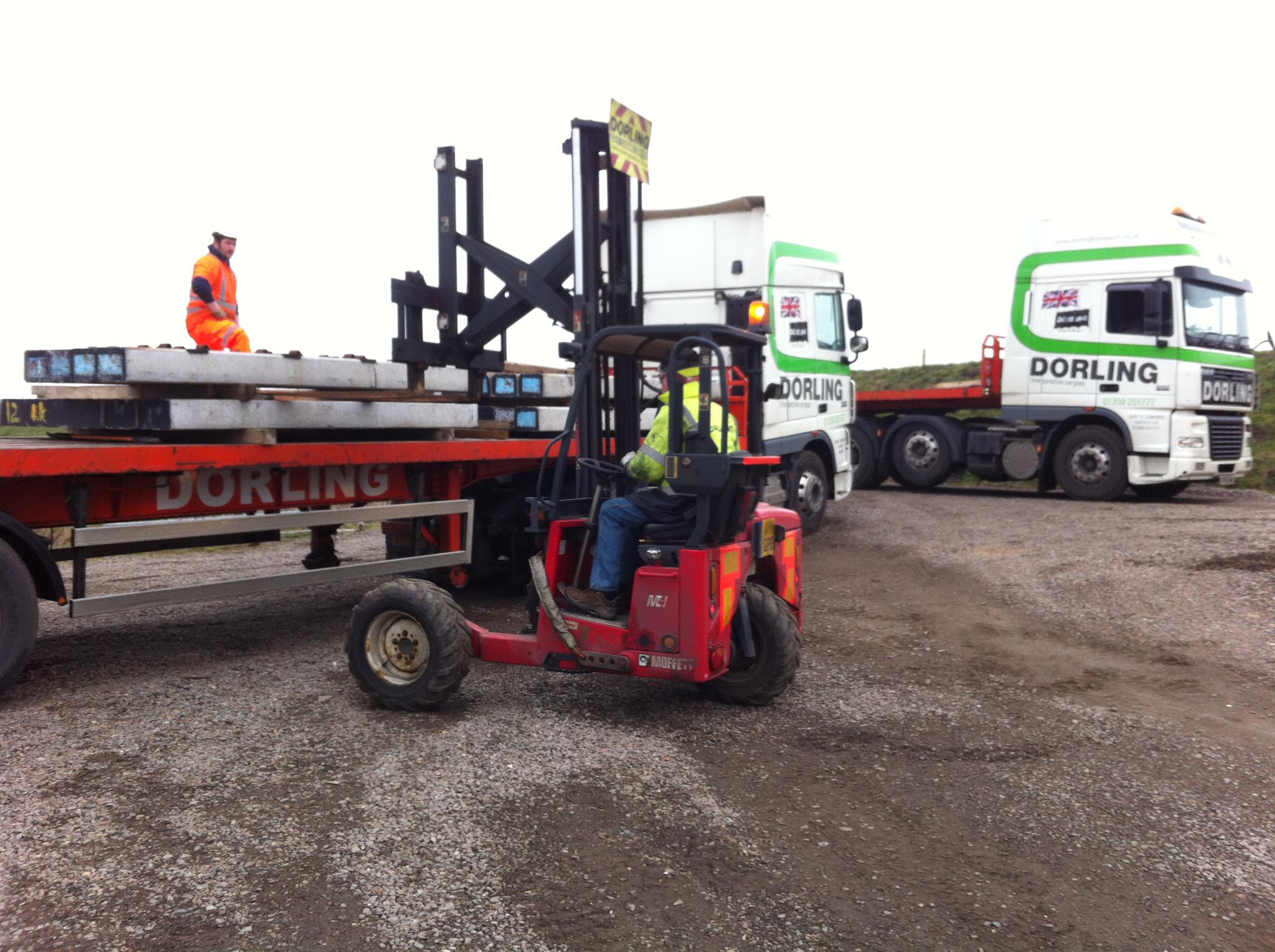 Truck Mounted Forklift delivering concrete beams to a construction site.